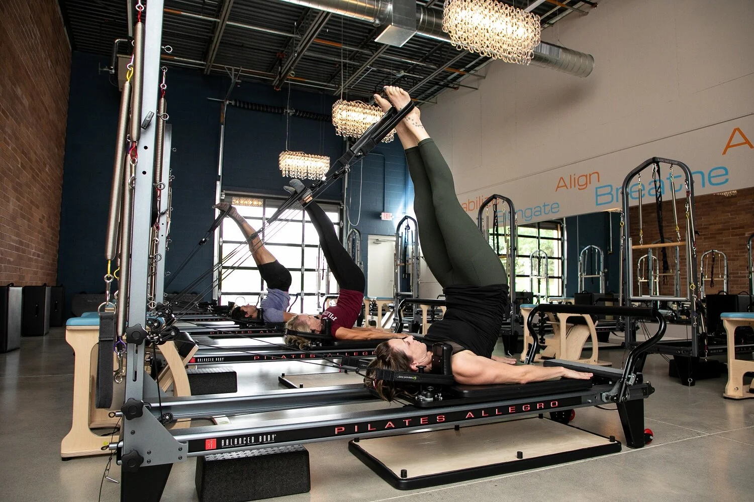A client working on a Konnector Reformer at Pilates MN in Plymouth